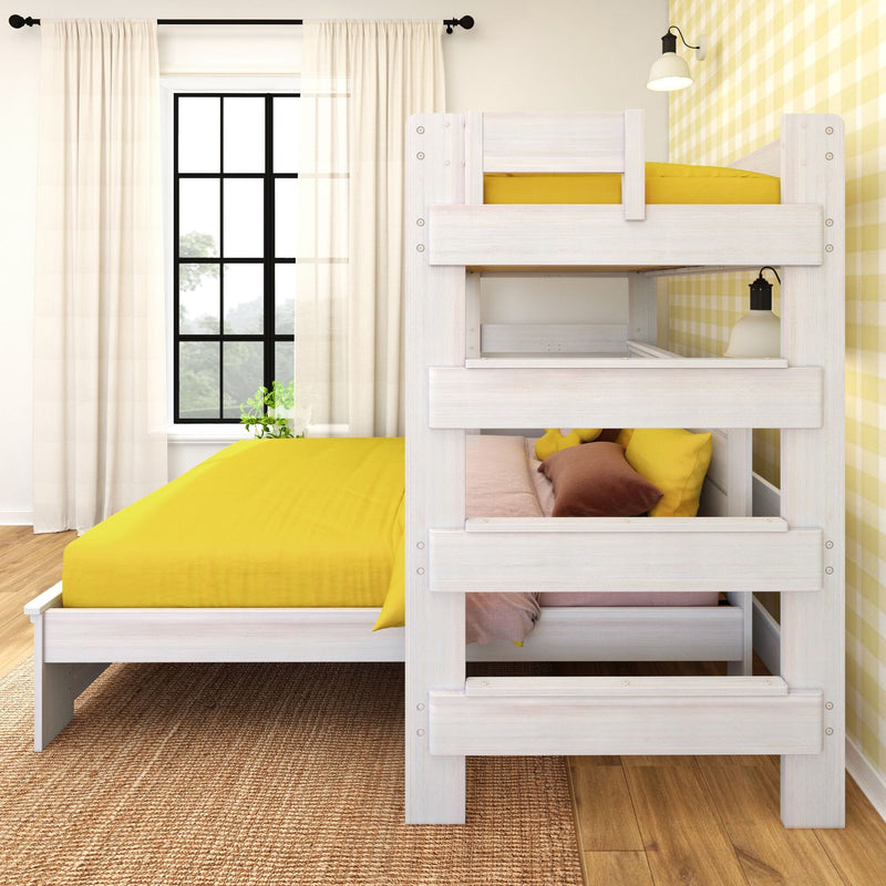 Whitewashed wood kids bunk bed with bright yellow bedding in sunlit children's bedroom with yellow gingham wallpaper and black-framed window