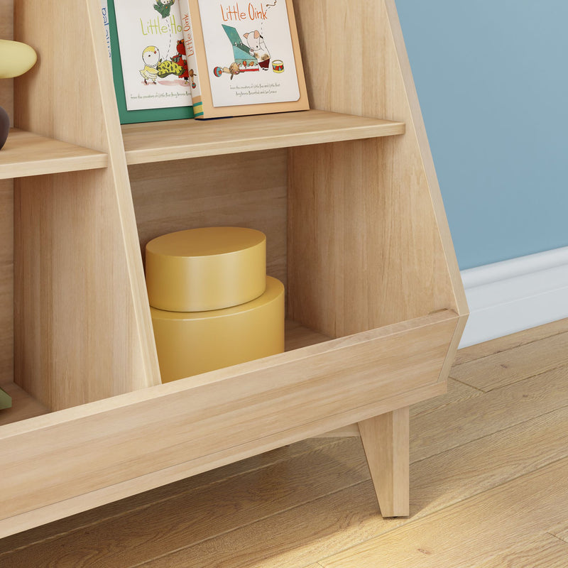 Modern children's nursery shelf with light wood finish, kids bookshelf holding illustrated picture books and yellow stacking toy in open cubby, blue wall and hardwood floor