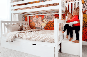 Solid wood twin over full bunk bed in white with storage and staircase with kids on steps
