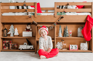 Wood twin loft bed with storage shelves and holiday decor