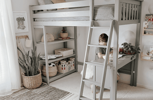 Grey wood twin high loft bed with desk and storage shelves in neutral kids bedroom