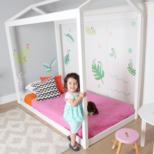 White twin house bed in colorful girls room