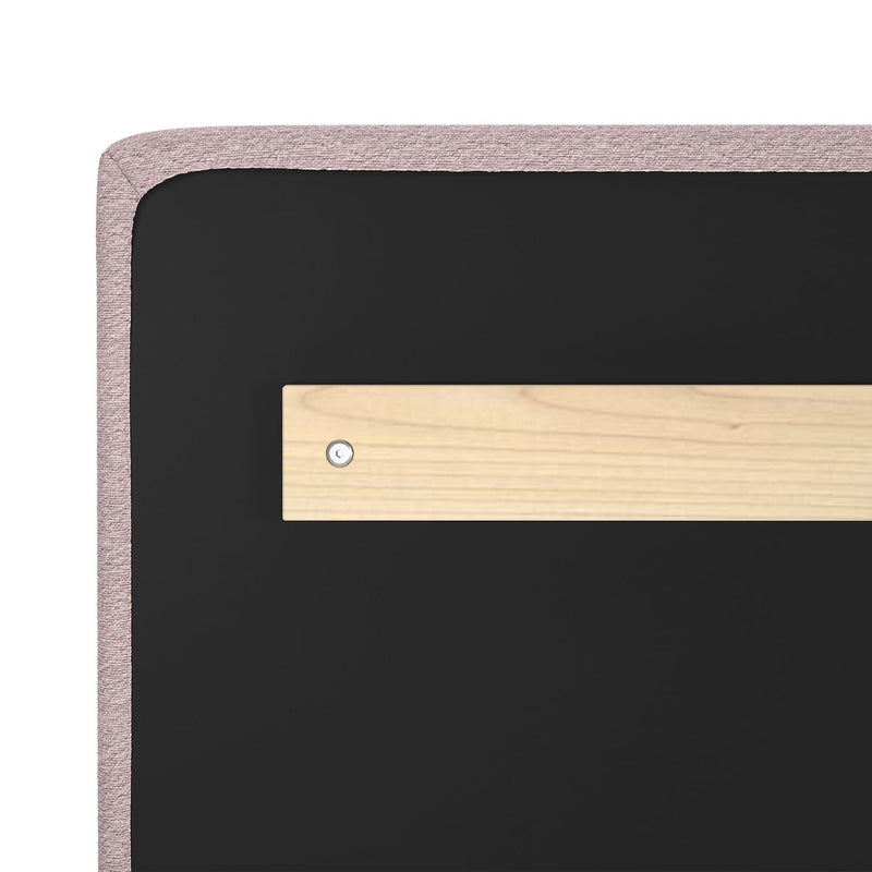 Pink upholstered headboard back view with black backing and wooden cleat wall-mounting hardware