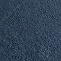 Close-up of navy blue textured carpet upholstery fabric with loop pile and dense woven fibers