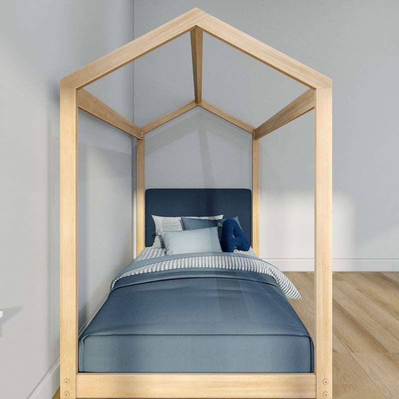 Wooden house-frame kids bed with navy blue bedding and striped pillows in a modern minimalist bedroom