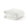 Folded white microfiber blanket on white background, perfect for cozy home decor and bedding.