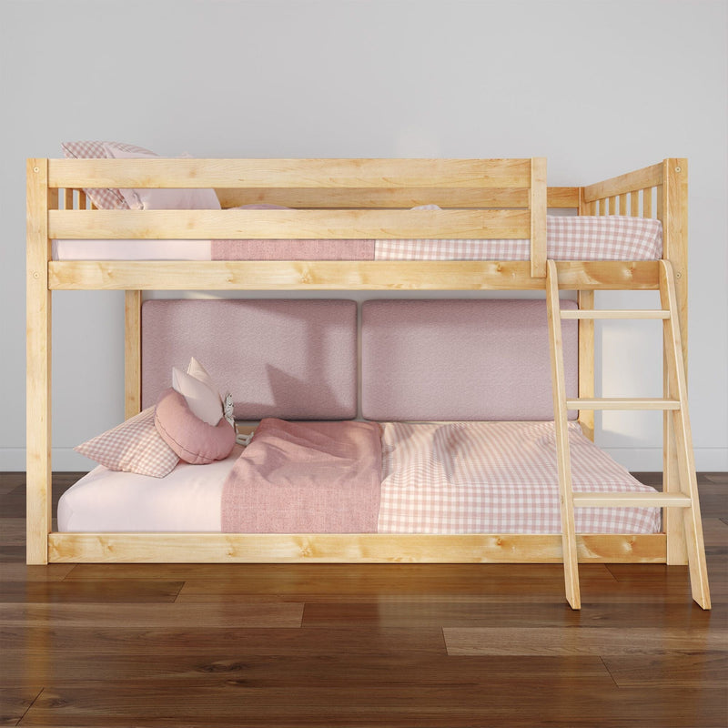 Natural wood bunk bed with pink gingham and blush bedding, ladder and hardwood floor in a modern kids' bedroom