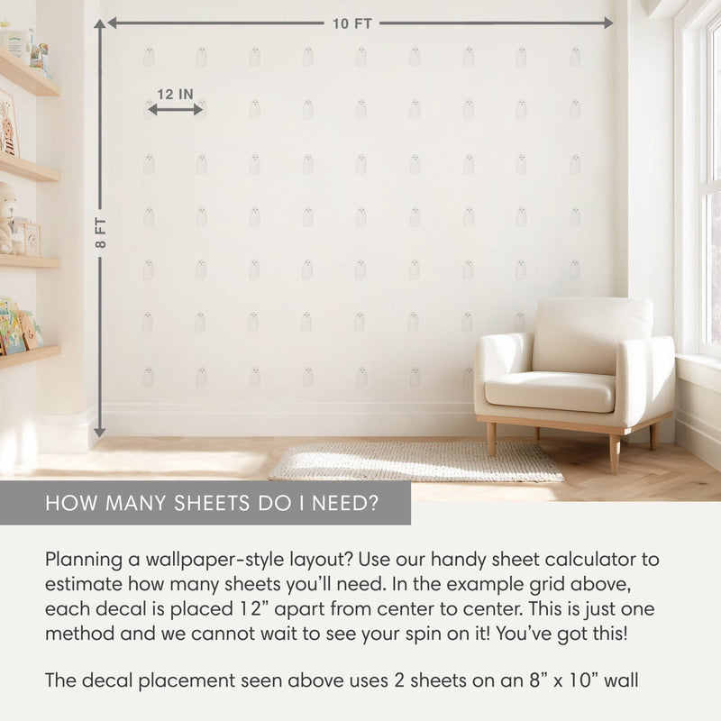 Nursery wall decal layout on 8 ft x 10 ft wall showing ghost-shaped vinyl decals in a 12-inch grid, light-filled room with armchair and shelves