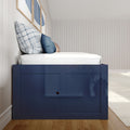Navy blue wooden bed with white mattress and blue plaid and solid throw pillows against a white vertical shiplap wall with framed blue abstract art, modern coastal bedroom design