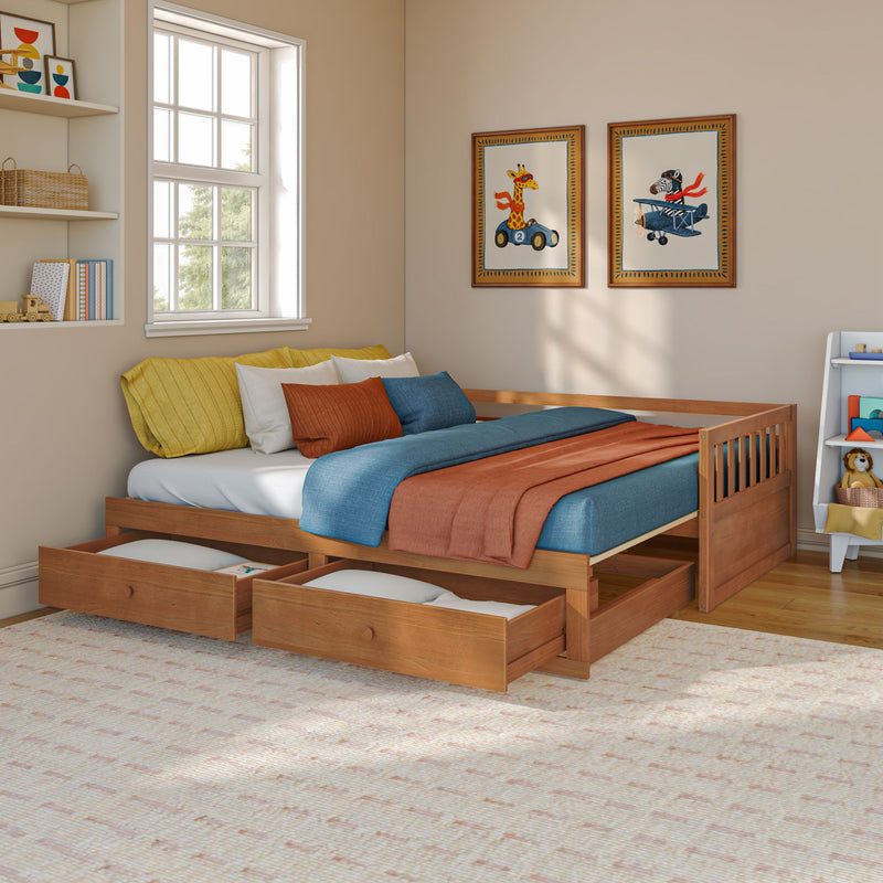 Children's bedroom with wooden trundle bed and under-bed storage drawers, teal and rust bedding, framed giraffe and zebra wall art, toy shelf and bright natural window light