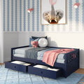 Children's bedroom nursery decor: navy blue daybed with under-bed storage drawers, pink elephant plush toy, pink throw blanket, round white pillow, framed elephant wall art and blue scallop striped wallpaper