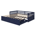 Navy blue wooden daybed frame with slatted wood mattress base, slatted back and side rails, and built-in underbed storage drawers for kids or guest room furniture
