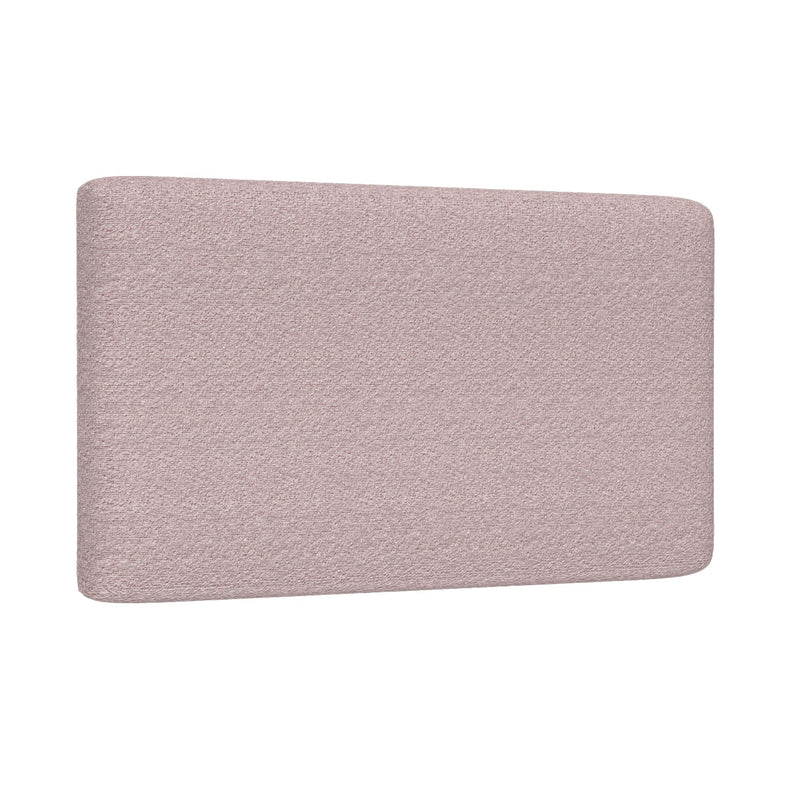 Blush pink upholstered headboard close-up showing textured fabric and rounded corners for a modern queen bed