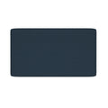 Close-up of navy blue textured rectangular bath mat with rounded corners on white background