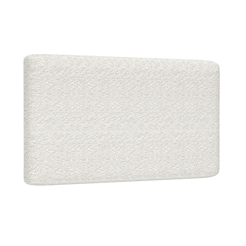 Close-up of a white textured mattress corner with rounded edge on a white background