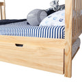 Natural pine toddler bed with navy blue striped bedding, anchor-print pillow, plush tiger toy, gray football cushion and under-bed storage drawer