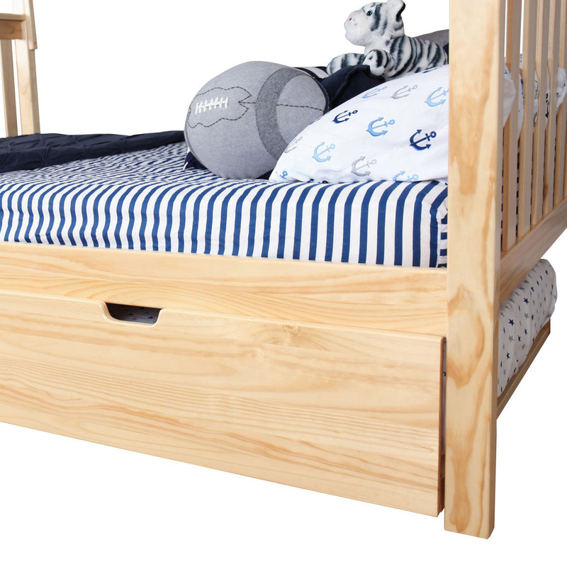 Natural pine toddler bed with navy blue striped bedding, anchor-print pillow, plush tiger toy, gray football cushion and under-bed storage drawer