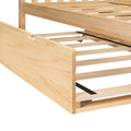 Light pine platform bed frame with slatted wooden base, underbed trundle rails and caster wheel, natural solid wood finish