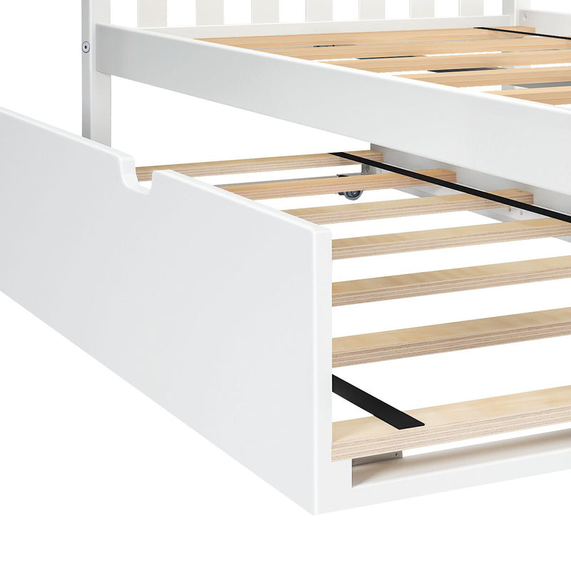 White wooden platform bed frame with natural wood slatted base and underbed pull-out trundle storage on casters, reinforced by black metal support strip