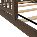Close-up of dark walnut wooden bed frame with slatted plywood mattress support and black metal center rail, showing side rail and headboard post