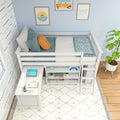 White wooden kids loft bed with built-in desk and storage shelves, teal bedding and orange accent pillow, coastal wall art and potted plant – children's bedroom décor