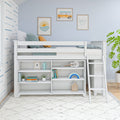 White kids loft bed with built-in storage shelves and ladder in a coastal-themed nursery — light blue walls, framed surf and sunset wall art, pastel pillows, toys and plants.