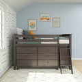 Dark wood loft bed with built-in dresser drawers and ladder in a coastal-themed kids bedroom with blue walls, pillows and beach artwork