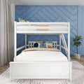 White wooden bunk bed with ladder and colorful pillows in a modern kids bedroom featuring a blue geometric accent wall and potted plant