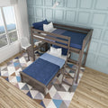 Modern twin-over-twin wooden bunk bed with navy blue bedding, ladder, geometric rug and light blue paneled wall in a bright kids' bedroom by a large window