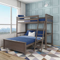 Modern wooden twin-over-full bunk bed with blue linens and ladder in a bright kids' bedroom with light-blue paneled wall and large window city view