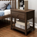 Walnut solid wood nightstand bedside table with single drawer and open shelf holding decorative storage boxes beside wooden bed frame on hardwood floor