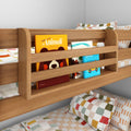Wooden bunk bed with built-in bookshelf holding colorful children's books and checkered pillows on patterned bedding in a kids' bedroom