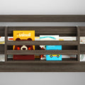 Dark wood wall-mounted three-tier children's bookshelf displaying colorful board books (animals, vehicles) in a nursery