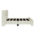 Modern beige fabric-upholstered platform bed frame with tall rounded headboard, wooden slats and low footboard on white background