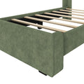 Green upholstered platform bed frame with evenly spaced wooden slats and fabric-wrapped low-profile base