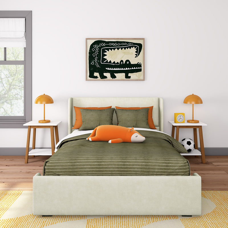 Kids bedroom decor with green striped bedding, orange accents and lamps, sleeping fox plush toy, framed crocodile wall art, bedside tables and soccer ball