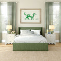 Green bedroom decor with upholstered green bed, white bedding and gingham pillows, framed green watercolor dog print, matching curtains and bedside lamps