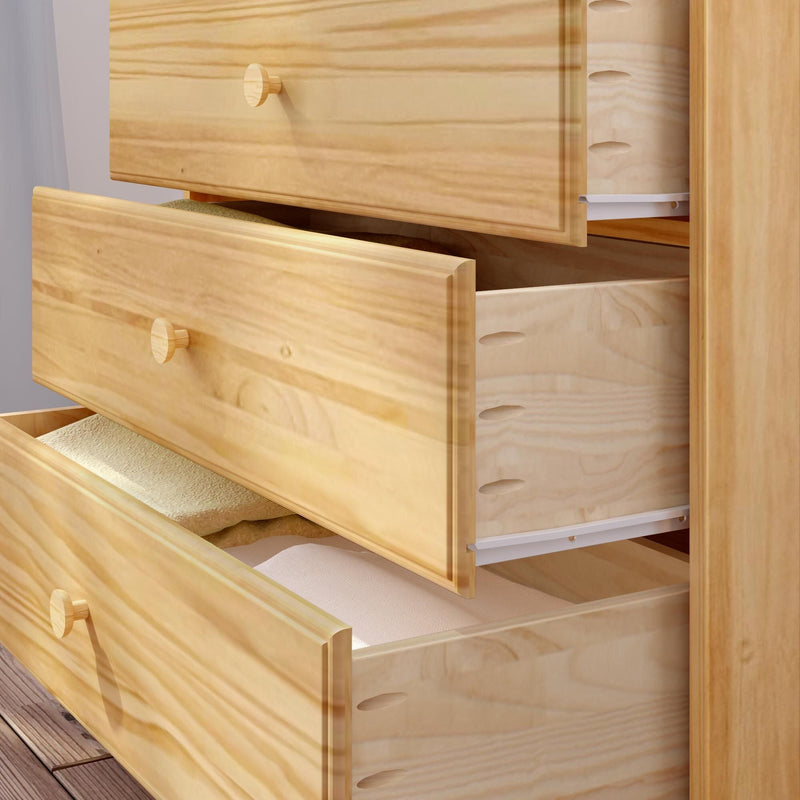 Light pine wood dresser with three open drawers revealing folded linens, natural-finish wooden chest of drawers for bedroom storage