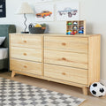 Light pine six-drawer dresser in a kids bedroom with a basket of plush toys, wooden toy cars in a cubby shelf, modern table lamp, car wall art, checkered rug and soccer ball — kids bedroom storage and nursery decor