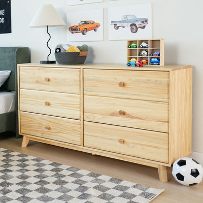 Six-drawer natural pine dresser in kids' bedroom for children's room storage with lamp, wooden toy car organizer, framed car art, toy cars and soccer ball