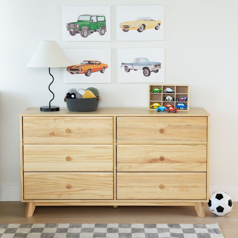 Natural wood six-drawer dresser in kids' bedroom with toy cars and wooden organizer, woven storage basket, modern lamp, car-themed wall art and soccer ball — children's room storage and decor