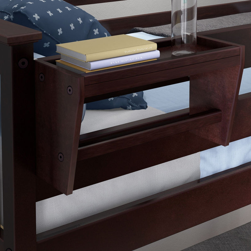 Close-up of a dark wooden bunk bed with a built-in bedside shelf holding stacked books, a clear glass, and a blue patterned pillow