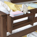 Wooden toddler bed with yellow bedding, striped elephant plush toy, pastel children's books and blue knitted blanket, nursery decor and kids bedroom accessories