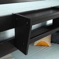 Modern black floating bedside shelf with built-in storage attached to bed frame over light blue bedding and yellow sunburst accent pillow — contemporary bedroom decor