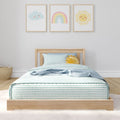Children's nursery bedroom with wooden twin bed, striped bedding and pastel wall art prints of smiling cloud, rainbow and sun
