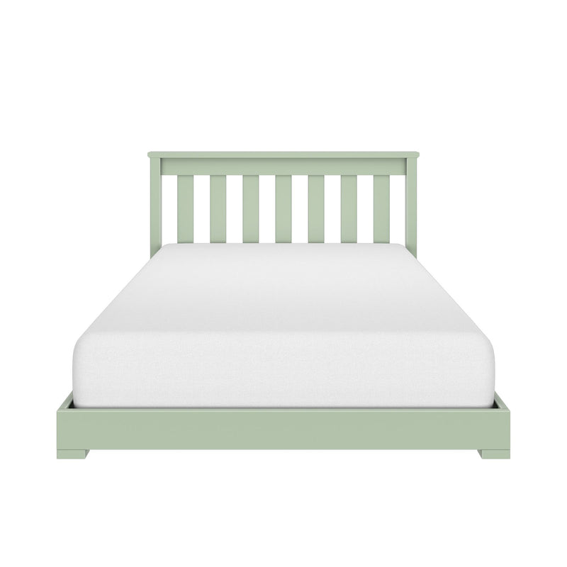 Green wooden twin bed frame with slatted headboard and white mattress on white background