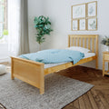 Minimalist bedroom with natural wood bed, blue polka-dot duvet, fiddle leaf fig, botanical wall art and sunlit window