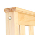 Close-up of natural pine wood furniture rail corner with exposed screw and vertical slatted panels, smooth light finish