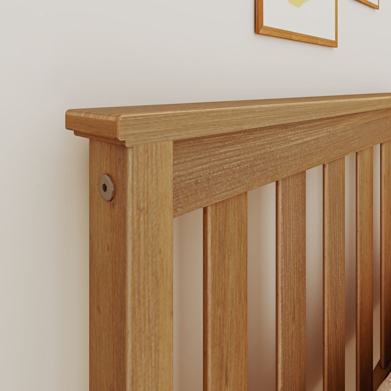 Close-up of light oak wooden headboard with vertical slats and visible bolt against a beige wall, modern bedroom furniture detail