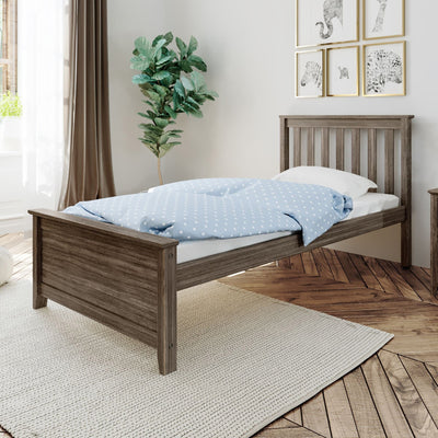 Bright modern bedroom with rustic wooden bed, blue polka-dot duvet, fiddle-leaf fig plant, framed animal prints and hardwood floor